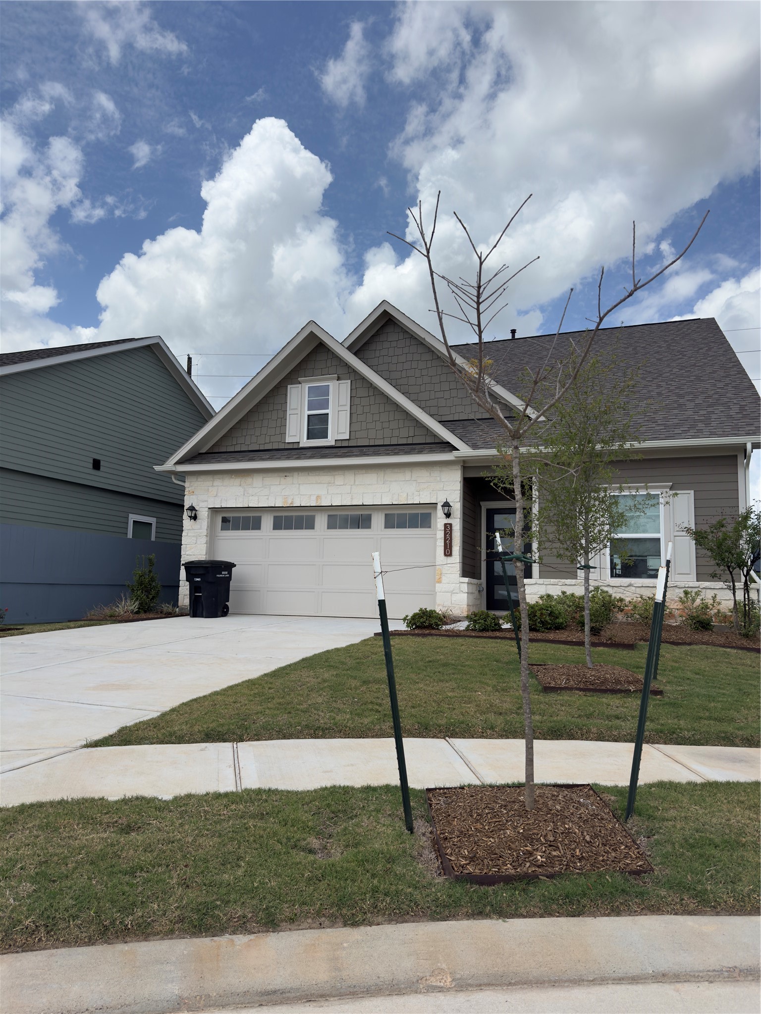 32210 Slender Spreadwing Drive Fulshear, TX 77441 - Photo 1 of 23 a front view of a house with a yard