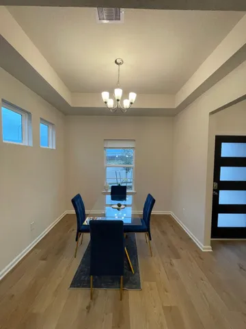 a dining room with furniture and chandelier