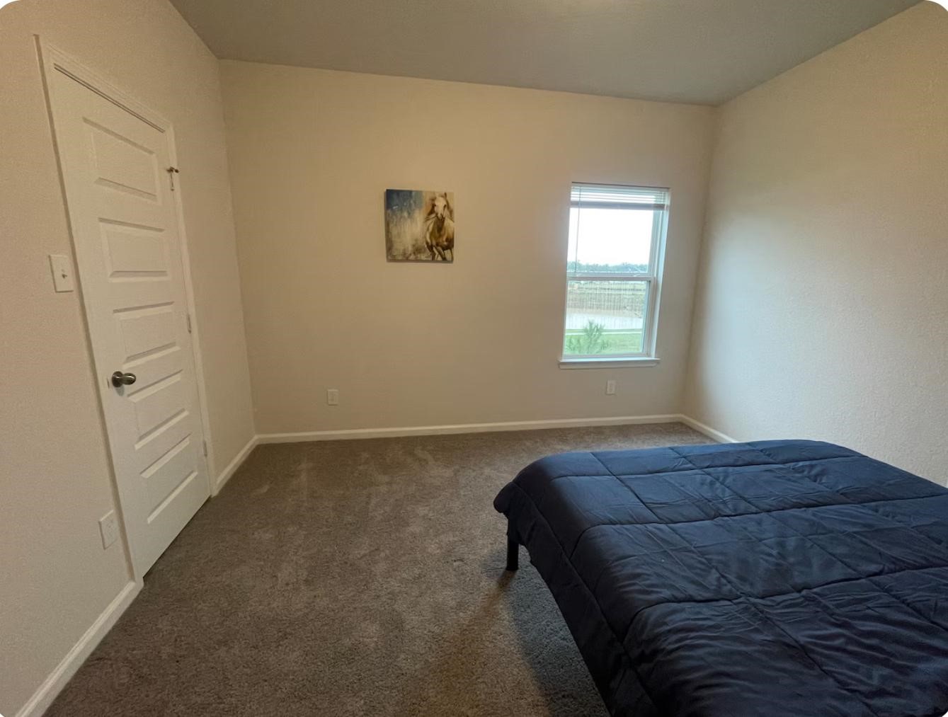 32210 Slender Spreadwing Drive Fulshear, TX 77441 - Photo 7 of 11 a bed sitting in a bedroom next to a window
