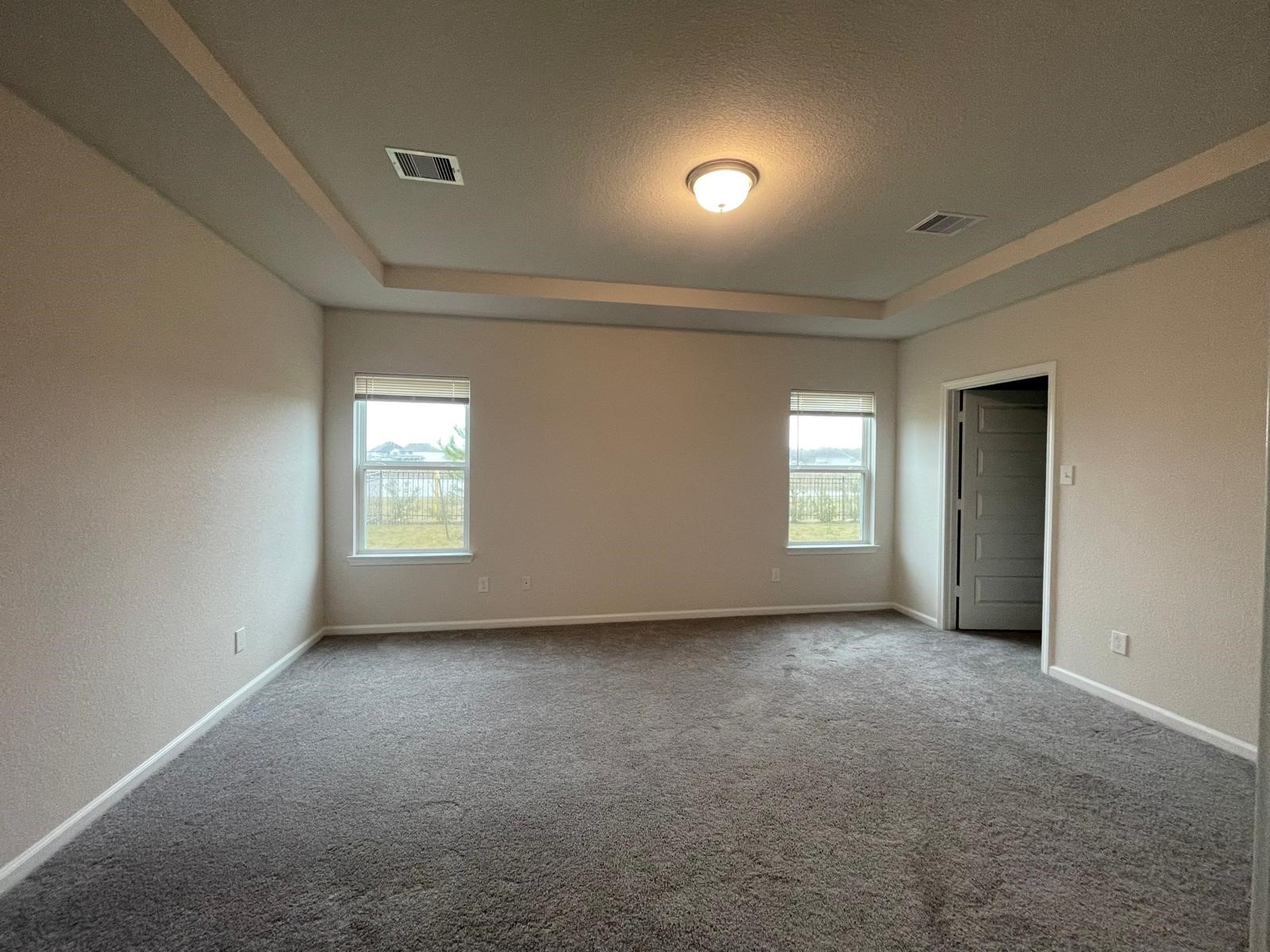 32210 Slender Spreadwing Drive Fulshear, TX 77441 - Photo 9 of 11 an empty room with windows