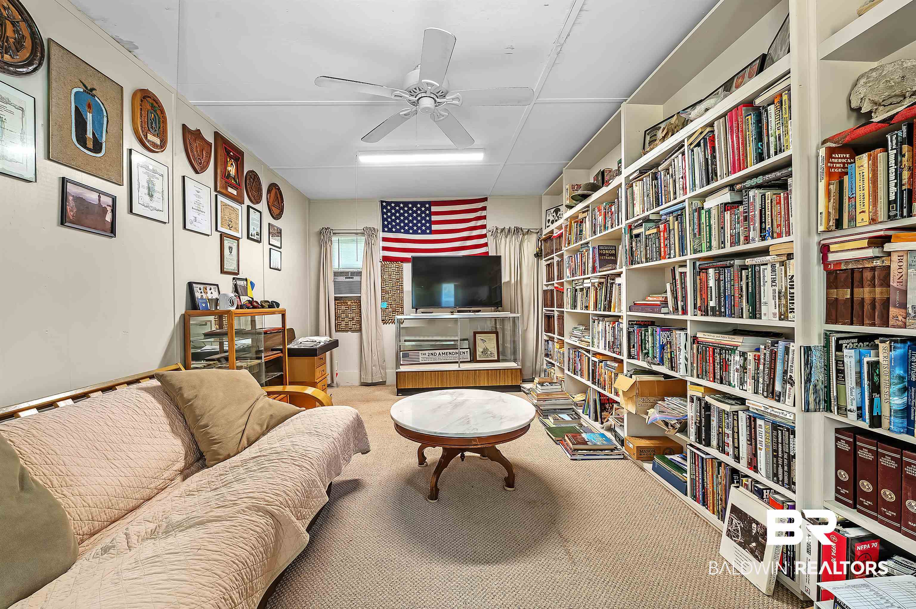 10970 Stucki Road Elberta, AL 36530 - Photo 39 of 56 Den area featuring built-in bookshelves, light carpet and ceiling fan