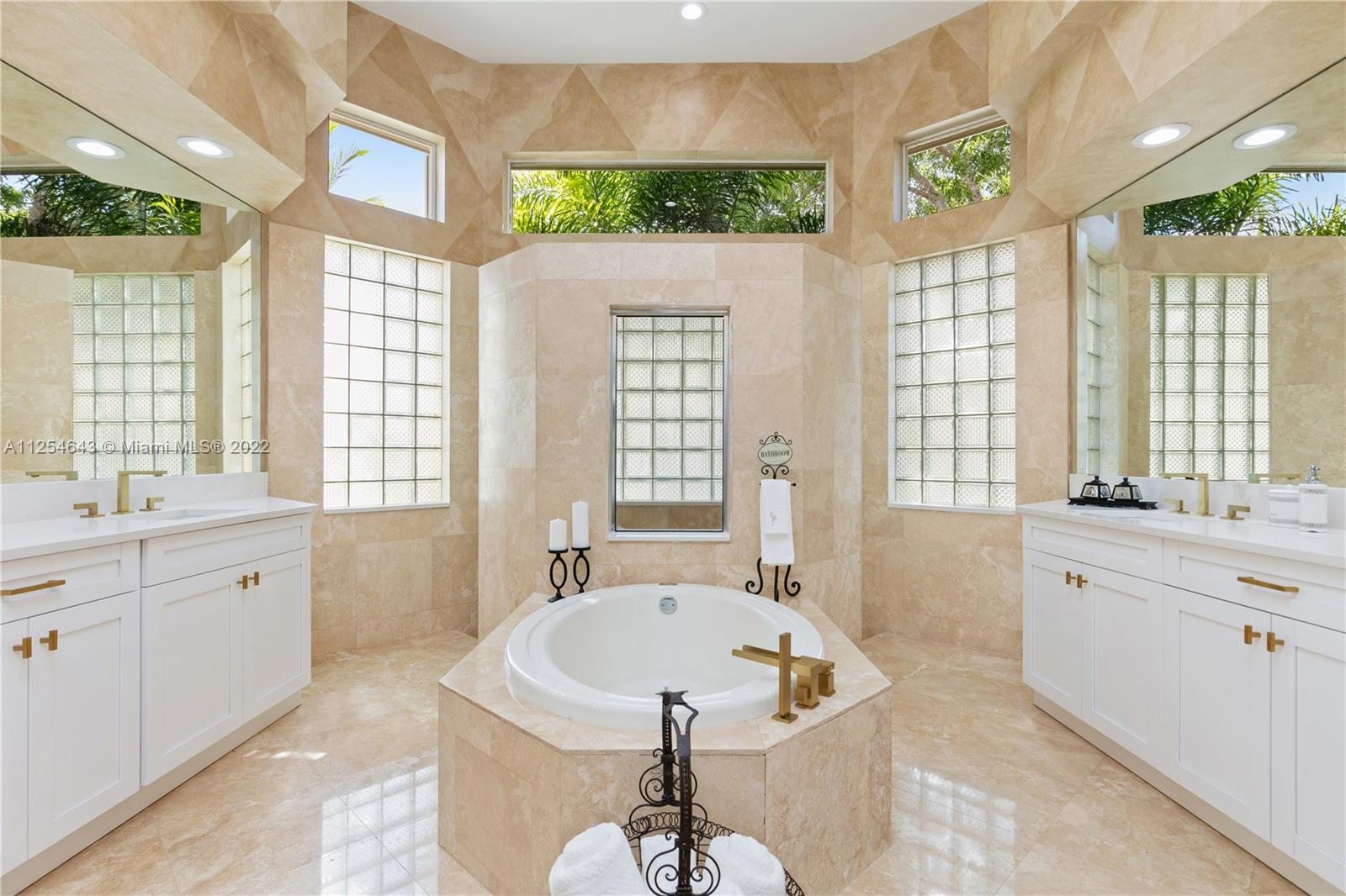 6563 Northwest 127th Terrace Parkland, FL 33076 - Photo 12 of 97 a spacious bathroom with a granite countertop tub sink and large window