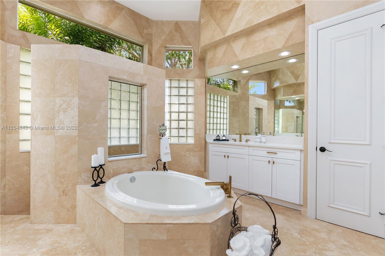 6563 Northwest 127th Terrace Parkland, FL 33076 - Photo 14 of 97 a bathroom with a bathtub and a sink