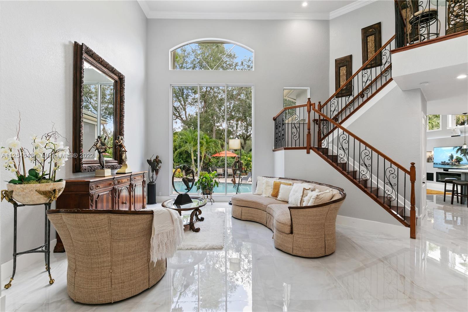 6563 Northwest 127th Terrace Parkland, FL 33076 - Photo 19 of 97 a living room with couches and a potted plant on a table