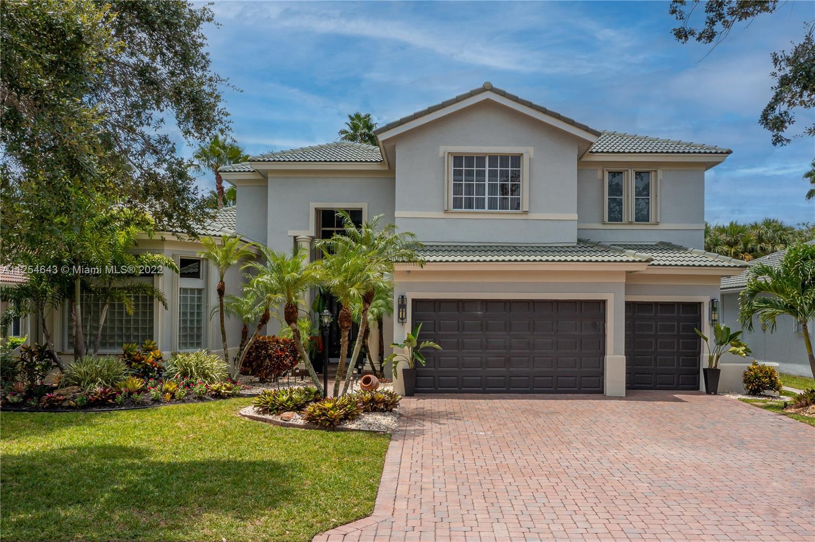 6563 Northwest 127th Terrace Parkland, FL 33076 - Photo 2 of 97 a front view of a house with a yard and garage