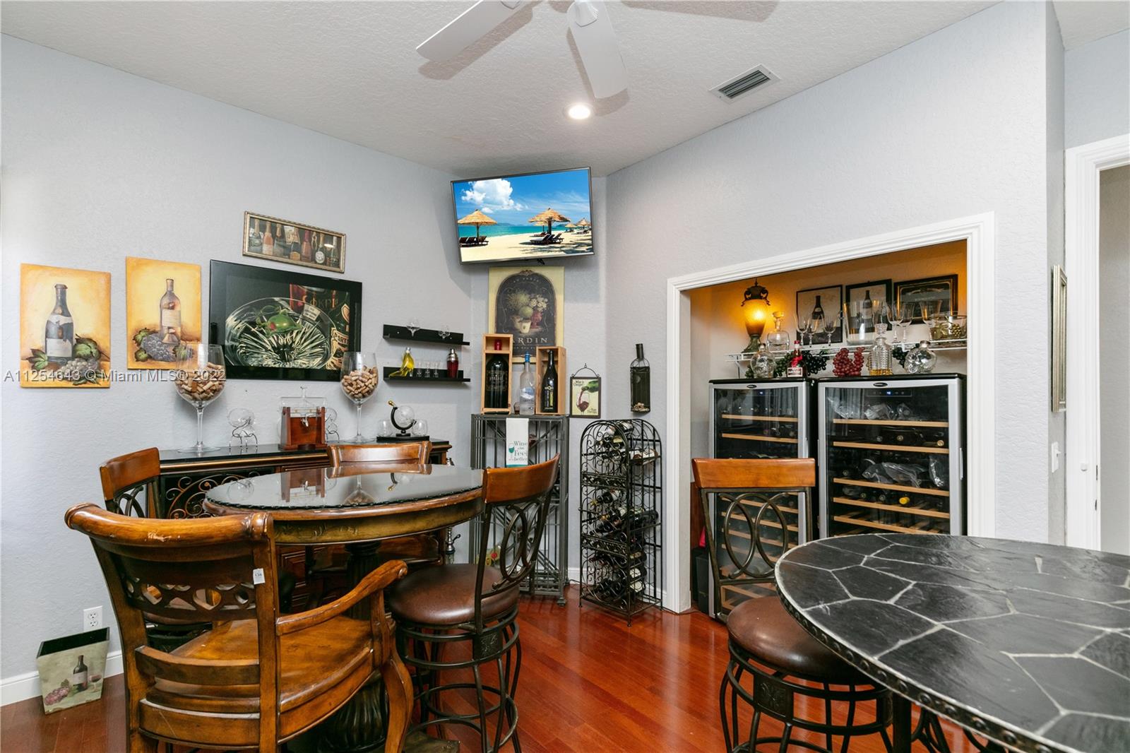 6563 Northwest 127th Terrace Parkland, FL 33076 - Photo 27 of 97 a dining room with furniture and wooden floor