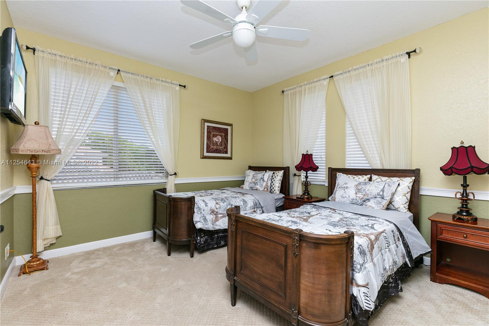 6563 Northwest 127th Terrace Parkland, FL 33076 - Photo 30 of 97 a bed room with a bed and a chandelier