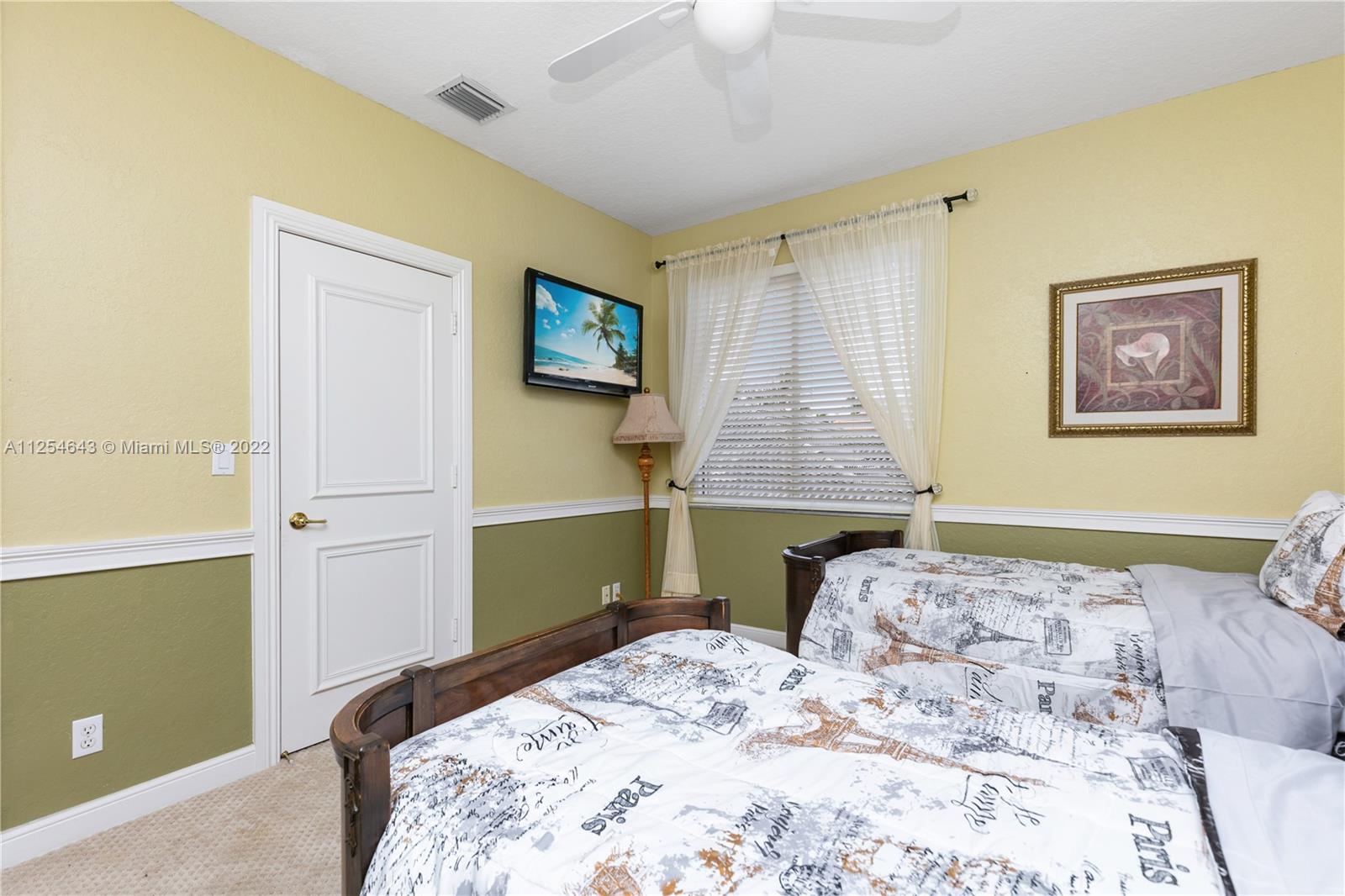 6563 Northwest 127th Terrace Parkland, FL 33076 - Photo 31 of 97 a bedroom with a bed and a painting on the wall