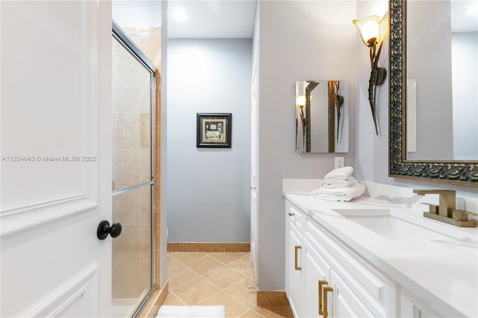 6563 Northwest 127th Terrace Parkland, FL 33076 - Photo 33 of 97 a bathroom with a sink and a mirror