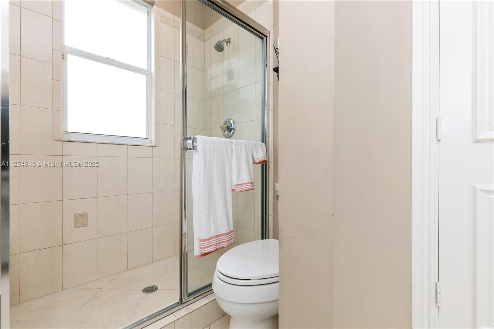 6563 Northwest 127th Terrace Parkland, FL 33076 - Photo 39 of 97 a bathroom with a granite countertop toilet and a shower