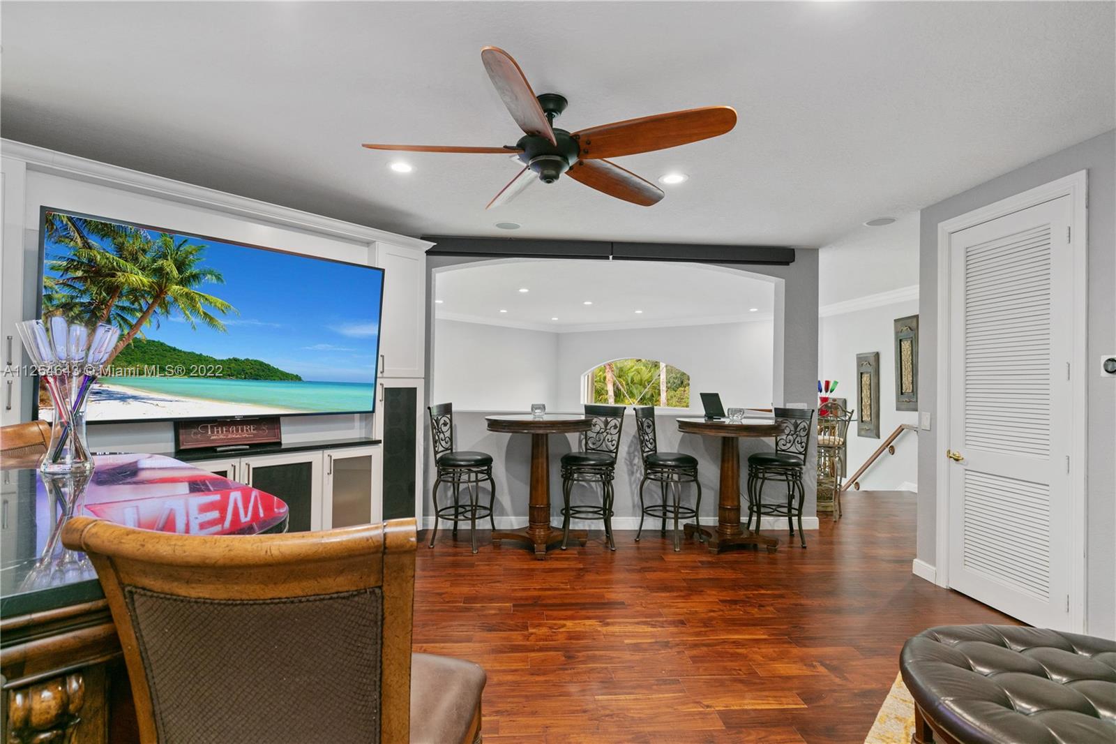 6563 Northwest 127th Terrace Parkland, FL 33076 - Photo 43 of 97 a dining room with furniture potted plants and wooden floor