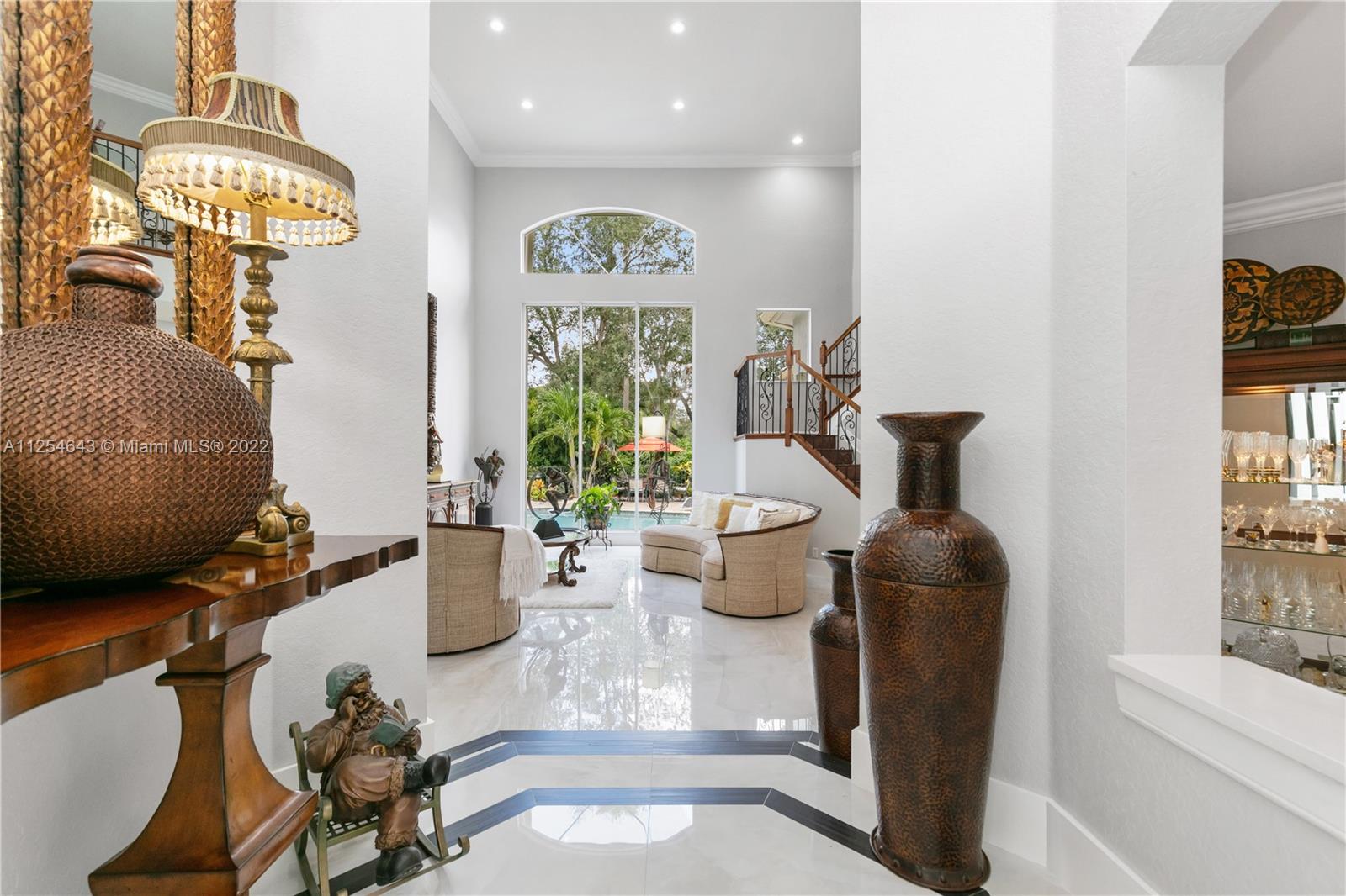 6563 Northwest 127th Terrace Parkland, FL 33076 - Photo 5 of 97 a view of a dining room with furniture a chandelier and wooden floor