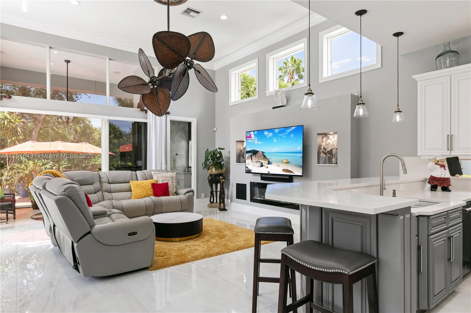 6563 Northwest 127th Terrace Parkland, FL 33076 - Photo 52 of 97 a living room with furniture kitchen view and a chandelier
