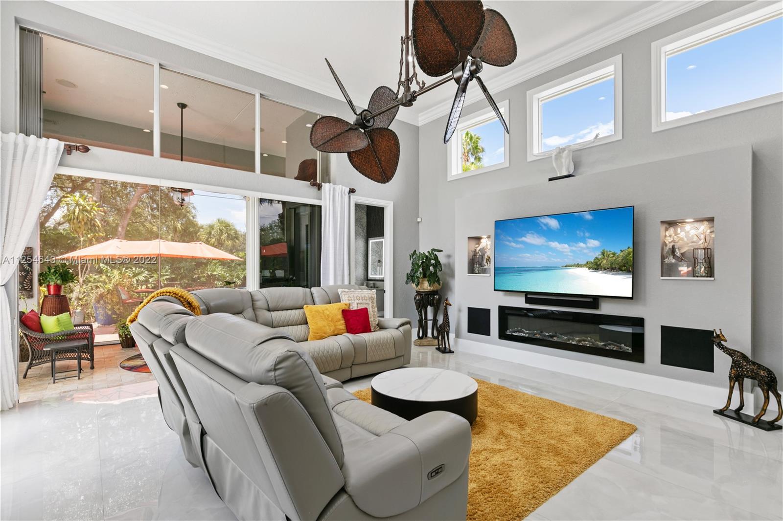 6563 Northwest 127th Terrace Parkland, FL 33076 - Photo 55 of 97 a living room with furniture and a flat screen tv