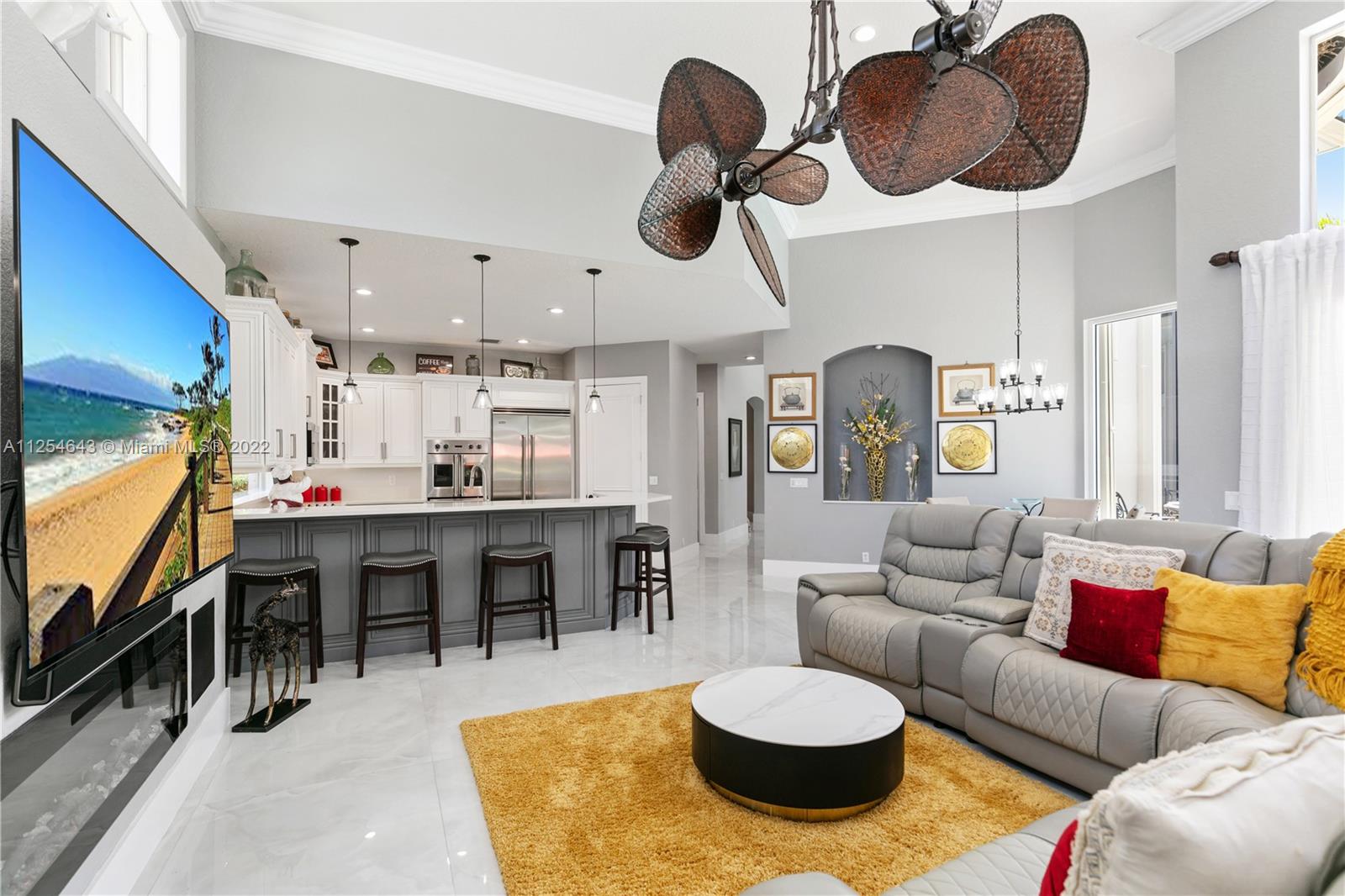 6563 Northwest 127th Terrace Parkland, FL 33076 - Photo 57 of 97 a living room with lots of furniture and kitchen view