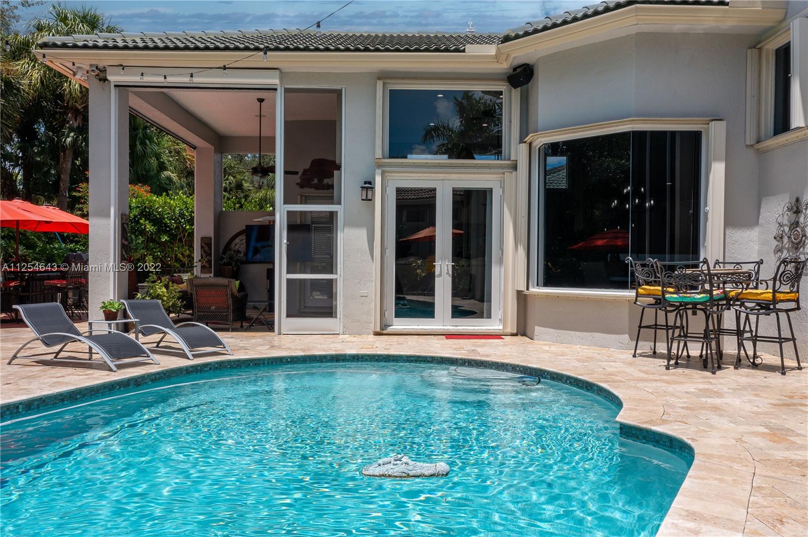 6563 Northwest 127th Terrace Parkland, FL 33076 - Photo 76 of 97 a view of a house with backyard porch and sitting area