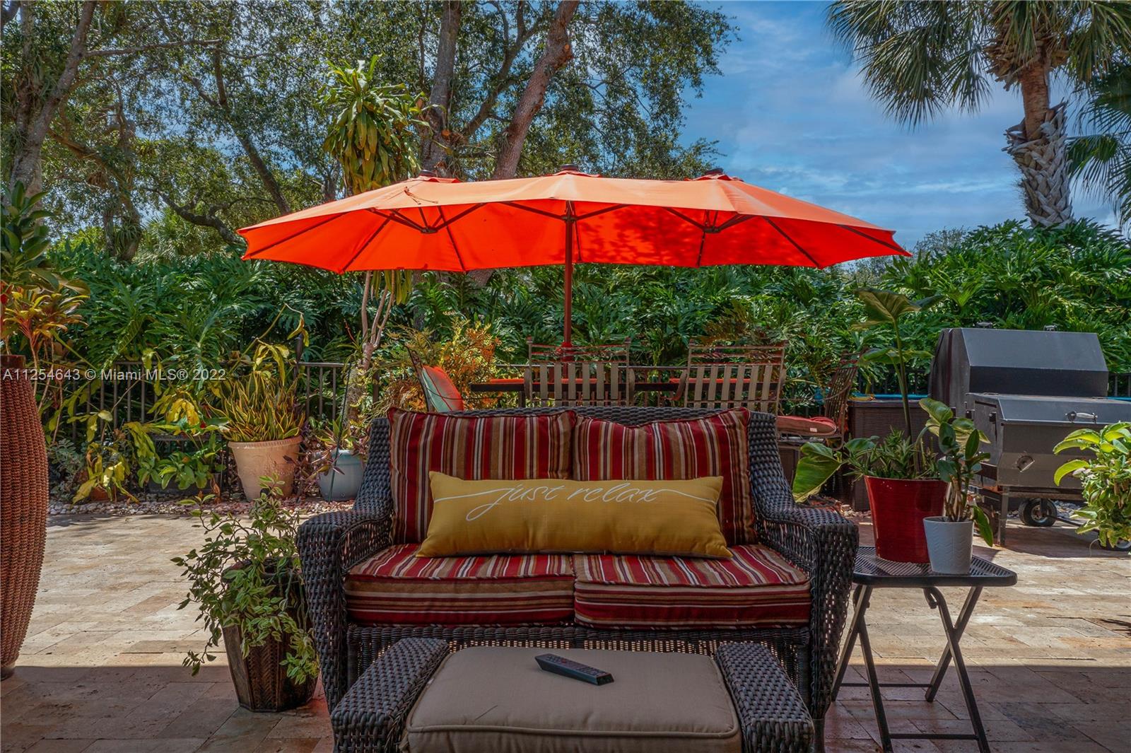 6563 Northwest 127th Terrace Parkland, FL 33076 - Photo 79 of 97 a view of table and chairs under an umbrella
