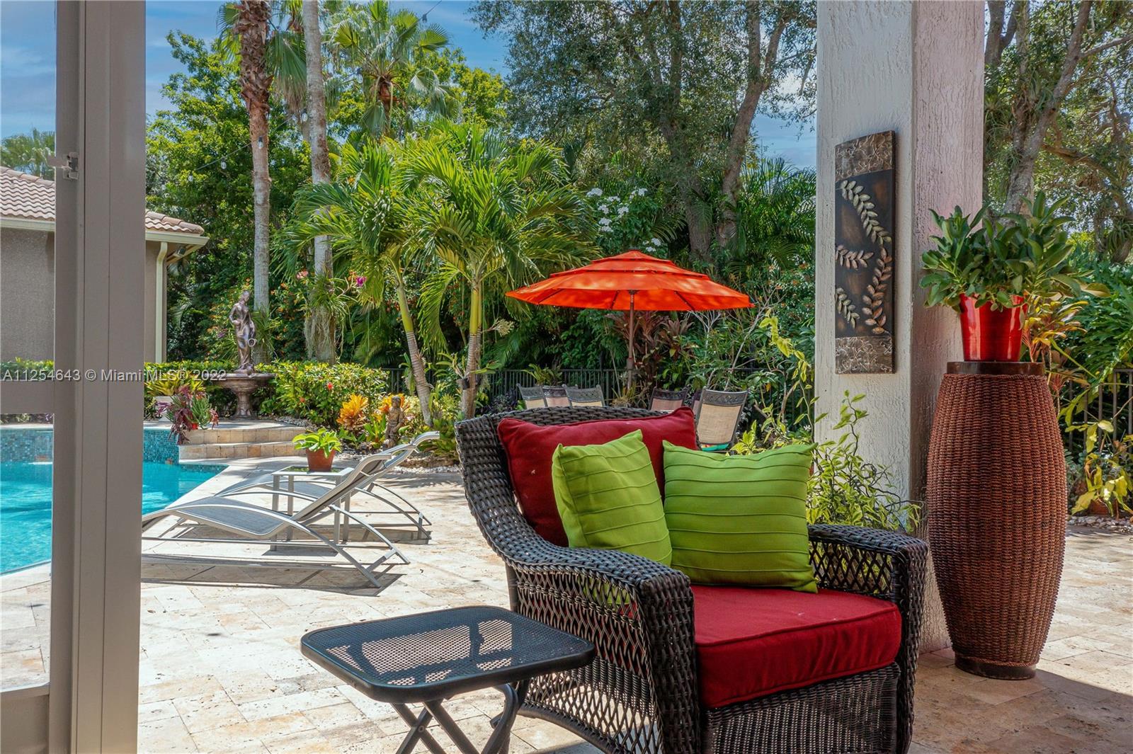 6563 Northwest 127th Terrace Parkland, FL 33076 - Photo 80 of 97 an outdoor sitting area with furniture and a garden