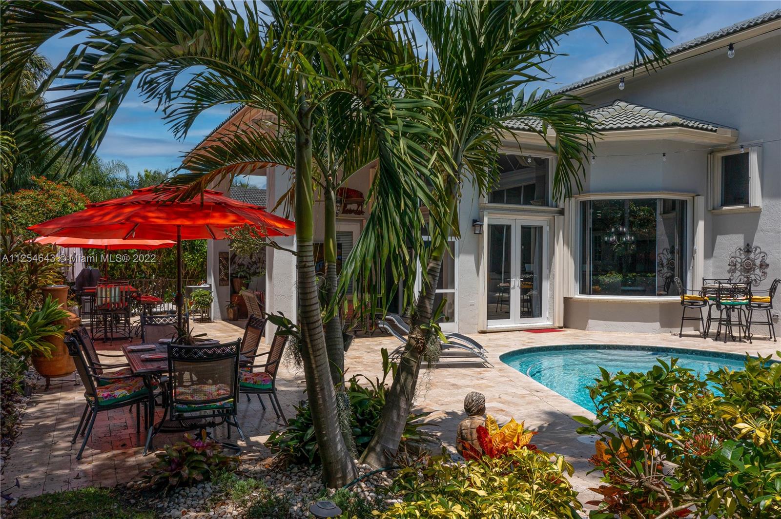 6563 Northwest 127th Terrace Parkland, FL 33076 - Photo 81 of 97 a view of a house with backyard sitting area and garden