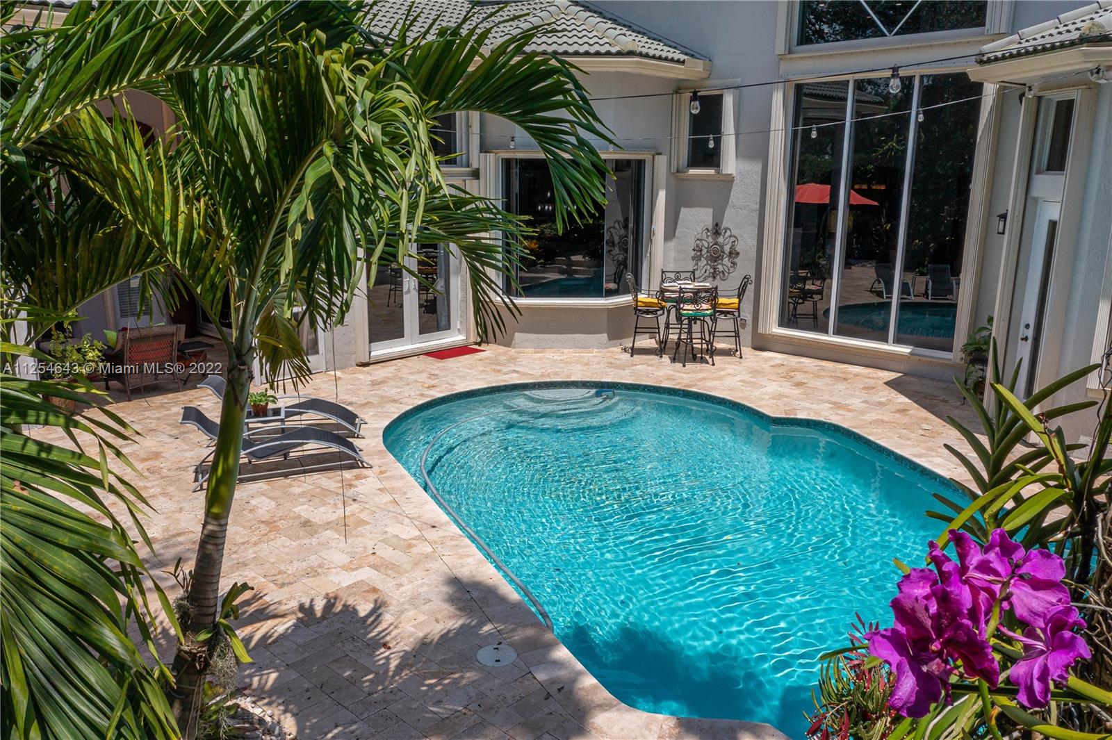 6563 Northwest 127th Terrace Parkland, FL 33076 - Photo 82 of 97 a view of a house with backyard porch and sitting area