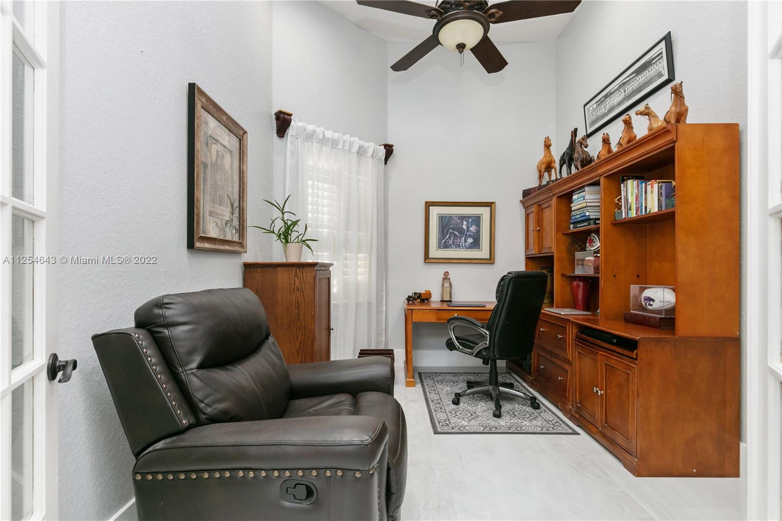 6563 Northwest 127th Terrace Parkland, FL 33076 - Photo 84 of 97 a work room with furniture and a book shelf