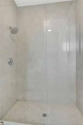 a bedroom with a bed and painting on the wall