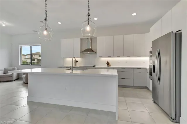 a kitchen with kitchen island a sink stainless steel appliances and cabinets