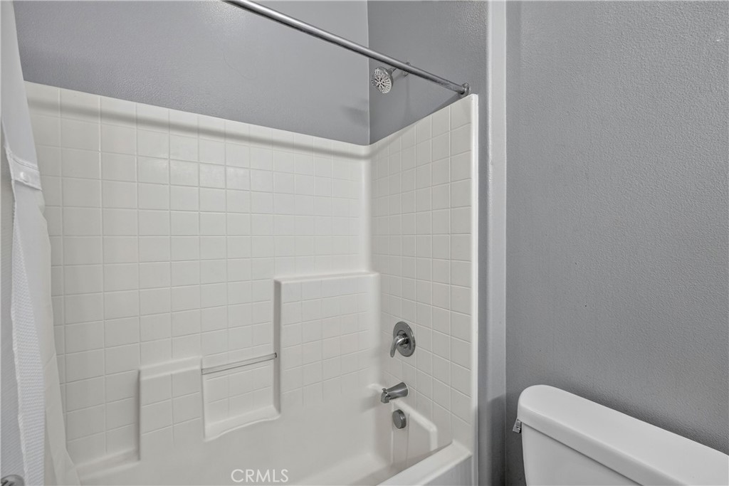 849 The Promenade, Unit D Azusa, CA 91702 - Photo 20 of 37 a bathroom with a bathtub and shower