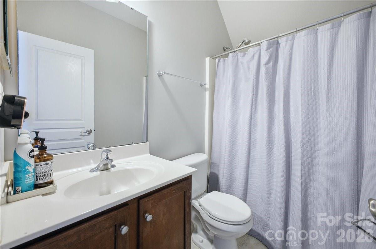 1825 Laveta Road Charlotte, NC 28269 - Photo 34 of 48 a bathroom with a sink a toilet and shower curtain