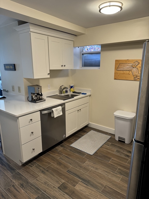 2 Sackville Street, Unit 1 Boston, MA 02129 - Photo 4 of 8 a kitchen with a stove cabinets and wooden floor