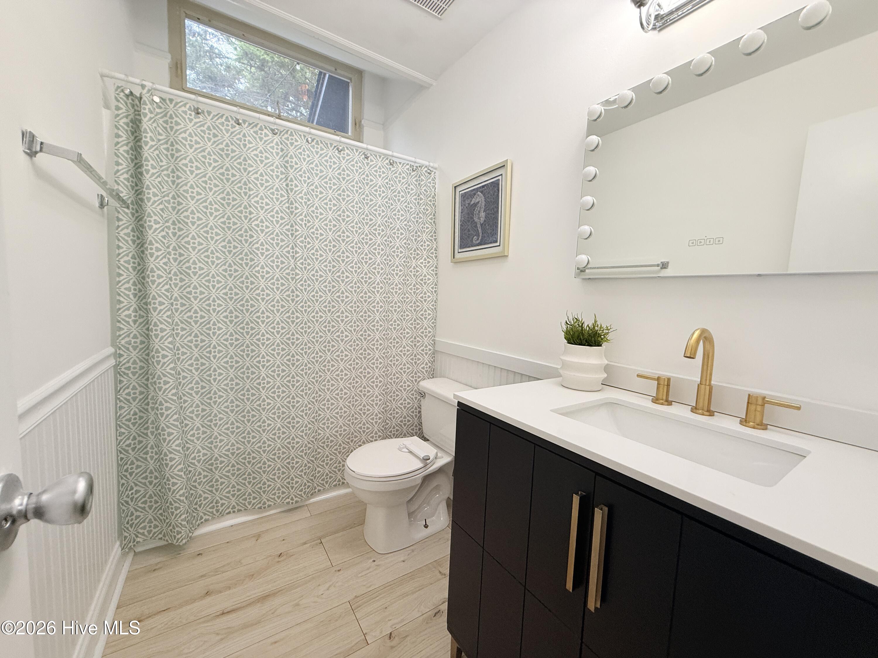 1001 Hunting Ridge Road Wilmington, NC 28412 - Photo 34 of 58 Good sized light and bright hall bath with beadboard wainscoting