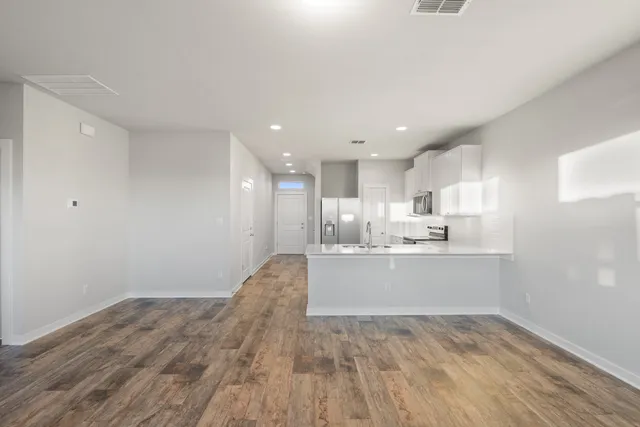 a view of a kitchen with white cabinets