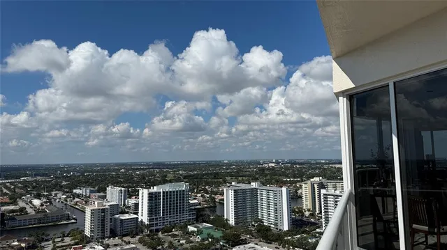 an aerial view of a house with garden space and lake view
