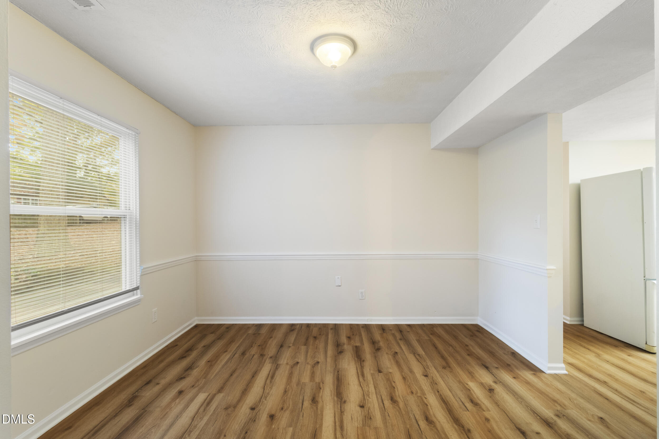 2001 Shenandoah Road Raleigh, NC 27603 - Photo 12 of 27 wooden floor in an empty room with a window