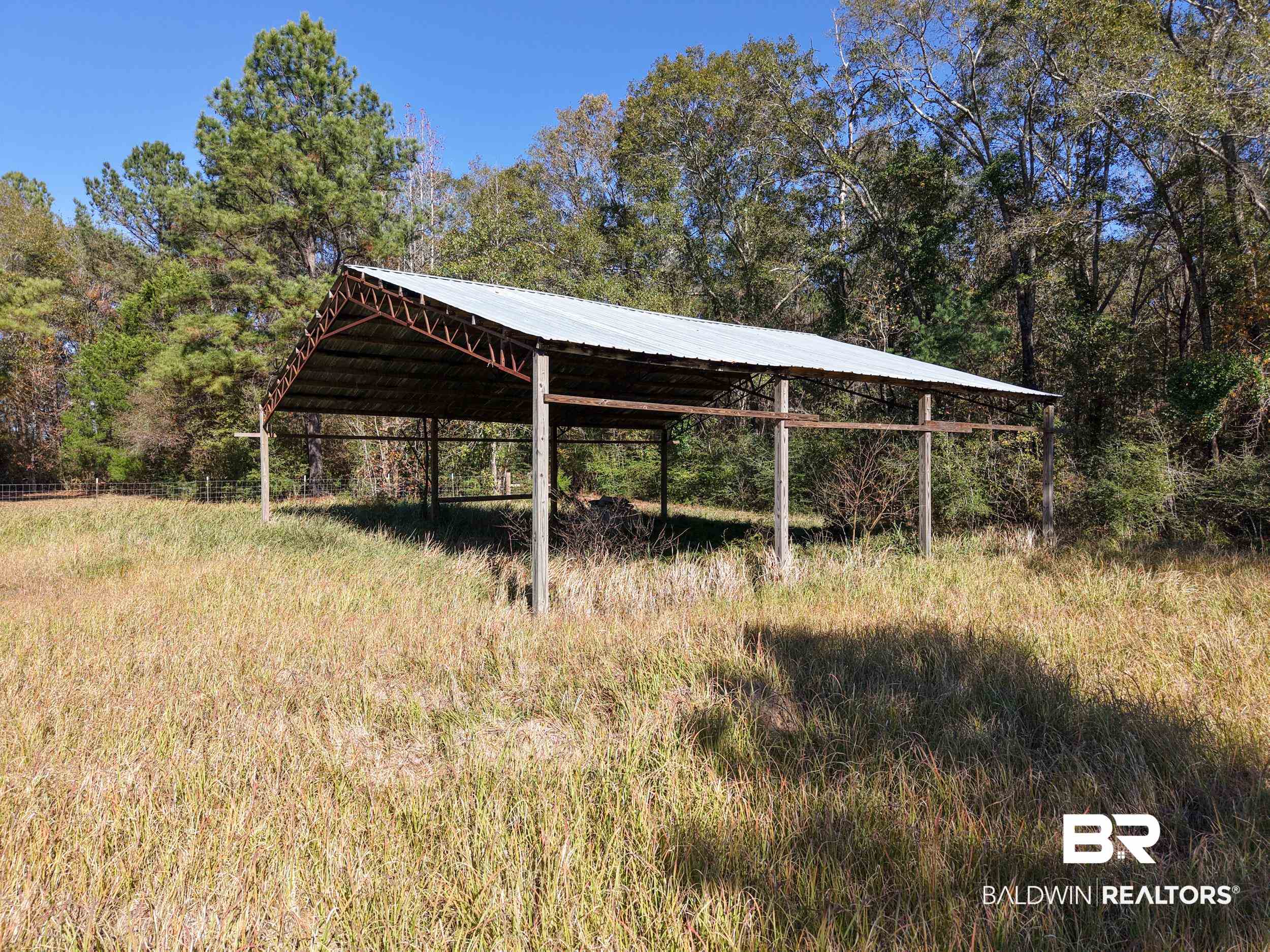 0 Stokley Court Atmore, AL 36502 - Photo 18 of 22 View of outbuilding with a carport and a view of trees