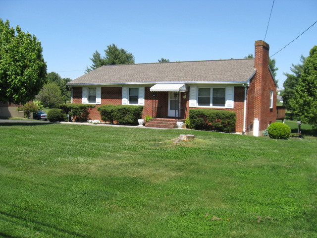 4003 Cove Road Roanoke, VA 24017 - Photo 1 of 14 a front view of a house with a yard and garage