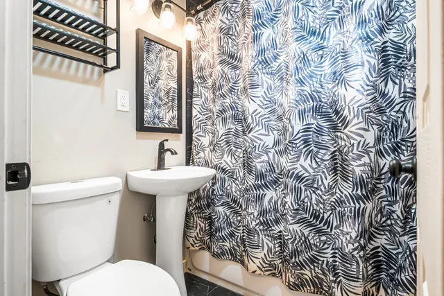a bathroom with a toilet sink and mirror