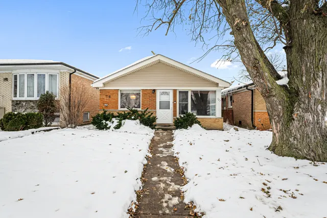 a view of a house with a yard covered in snow
