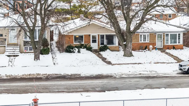 a view of a house with snow on the road