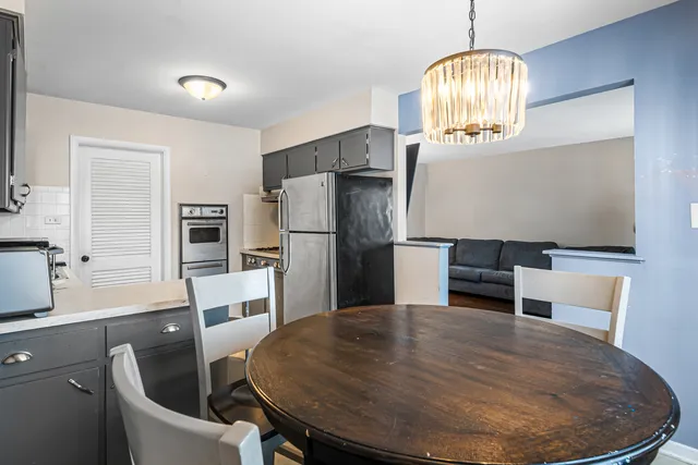 a kitchen with stainless steel appliances granite countertop a sink refrigerator and microwave