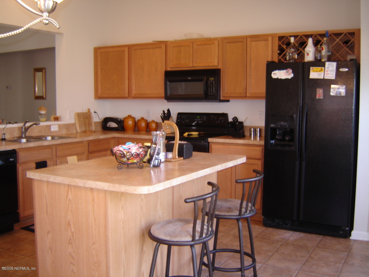 1141 Dawn Light Road Jacksonville, FL 32218 - Photo 5 of 9 a kitchen with a sink a stove and chairs