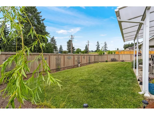 a view of yard with swimming pool and seating area