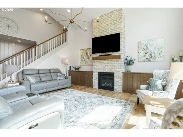 a living room with furniture fireplace and flat screen tv