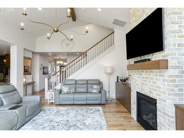a living room with fireplace furniture and a flat screen tv