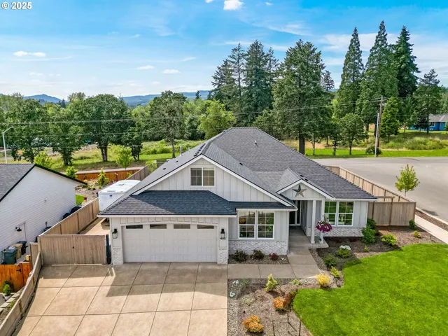 a aerial view of a house next to a yard