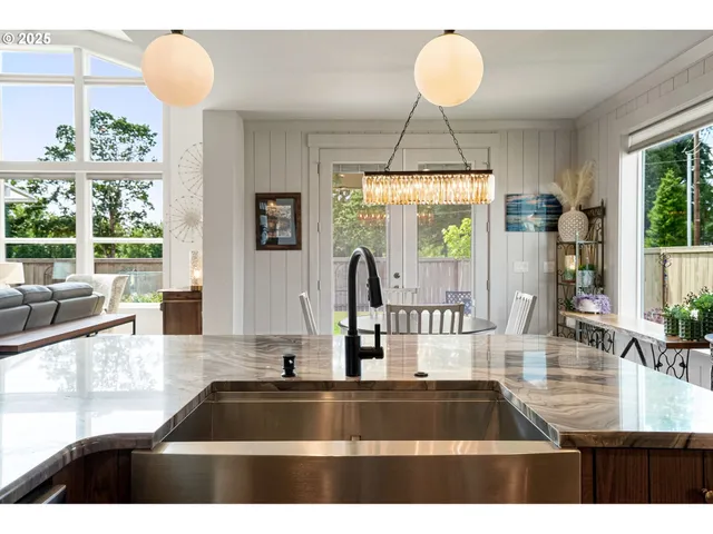 a kitchen with sink refrigerator and window