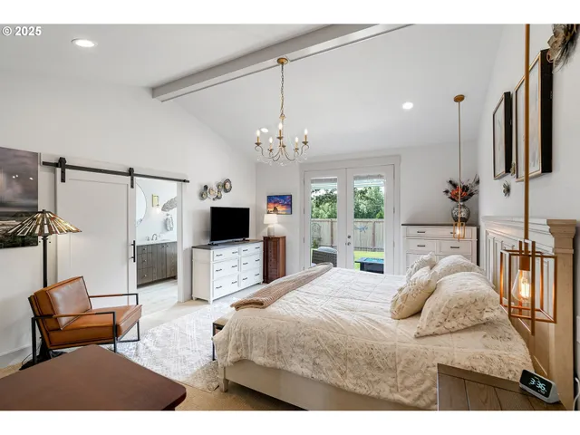 a bedroom with a bed a couch and dresser