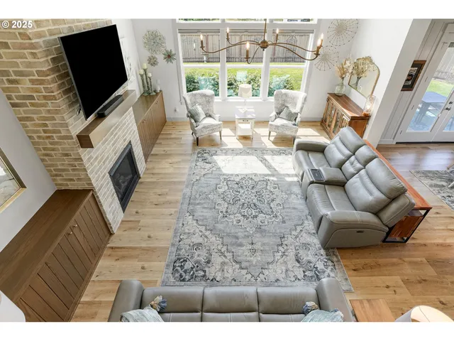 a living room with fireplace furniture and a flat screen tv