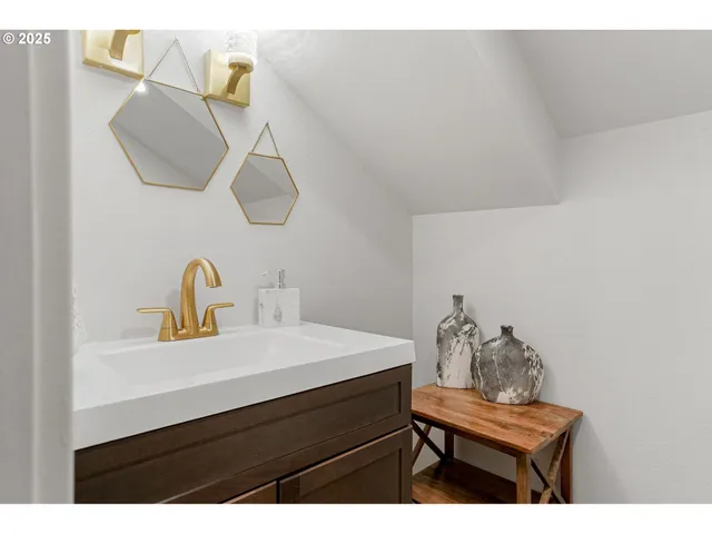 a bathroom with a sink vanity and a mirror