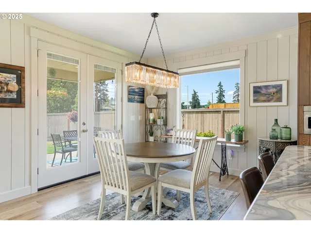 a dining room with furniture a chandelier and wooden floor